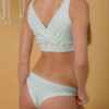 Woman wearing organic cotton mint brazilian cut bikini and mint top