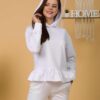 Woman with brown hair wearing white long-sleeved sweatshirt with a hood and ruffles and white organic cotton long pants