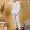 Woman with brown hair wearing white long-sleeved sweatshirt with a hood and ruffles and white organic cotton long pants