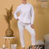 Woman with brown hair wearing white long-sleeved sweatshirt with a hood and ruffles and white organic cotton long pants