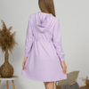 Woman with blond hair wearing organic cotton violet hooded dress
