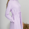 Woman with blond hair wearing organic cotton violet hooded dress