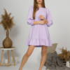 Woman with blond hair wearing violet organic cotton dress with bouffant sleeves