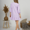 Woman with blond hair wearing violet organic cotton dress with bouffant sleeves