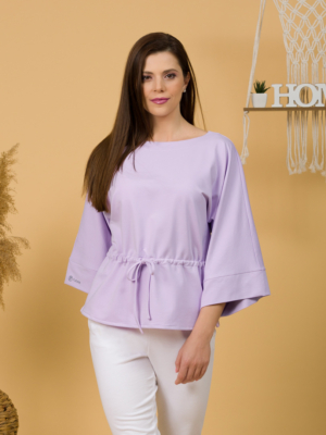 Woman with brown hair wearing violet organic cotton wide sleeves blouse and violet organic cotton long pants