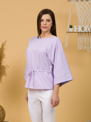 Woman with brown hair wearing violet organic cotton wide sleeves blouse and violet organic cotton long pants