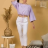 Woman with brown hair wearing violet organic cotton wide sleeves blouse and violet organic cotton long pants