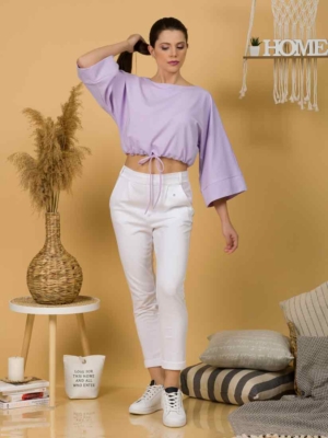Woman with brown hair wearing violet organic cotton wide sleeves blouse and violet organic cotton long pants