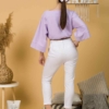 Woman with brown hair wearing violet organic cotton wide sleeves blouse and violet organic cotton long pants