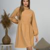 Woman with blond hair wearing organic cotton doe color polo dress