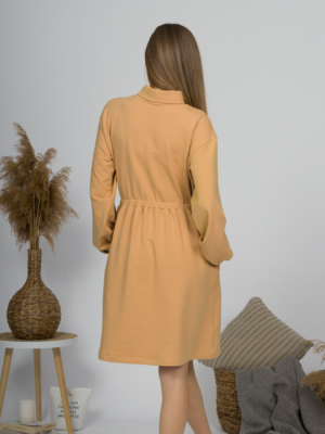 Woman with blond hair wearing organic cotton doe color polo dress