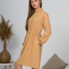 Woman with blond hair wearing organic cotton doe color polo dress