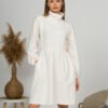 Woman with blond hair wearing organic cotton white semi-polo dress