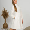 Woman with blond hair wearing organic cotton white semi-polo dress