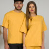 A young woman with blond hair wearing organic cotton yellow t-shirt and yellow straight leg trousers and a young man with black hair wearing organic cotton yellow t-shirt and black trousers