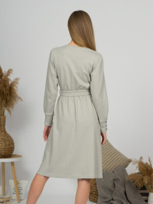Woman with blond hair wearing organic cotton gray color long sleeves dress with coconut buttons