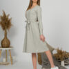 Woman with blond hair wearing organic cotton gray color long sleeves dress with coconut buttons