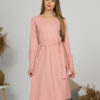 Woman with blond hair wearing organic cotton pink color long sleeves dress with coconut buttons