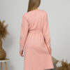 Woman with blond hair wearing organic cotton pink color long sleeves dress with coconut buttons
