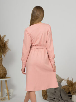 Woman with blond hair wearing organic cotton pink color long sleeves dress with coconut buttons