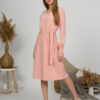 Woman with blond hair wearing organic cotton pink color long sleeves dress with coconut buttons
