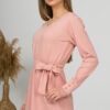 Woman with blond hair wearing organic cotton pink color long sleeves dress with coconut buttons