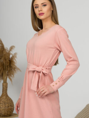 Woman with blond hair wearing organic cotton pink color long sleeves dress with coconut buttons