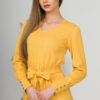 Woman with blond hair wearing organic cotton yellow color long sleeves dress with coconut buttons