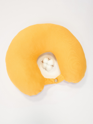 Travel pillow made of organic cotton with hypoallergenic down filling in yellow color