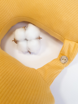 Travel pillow made of organic cotton with hypoallergenic down filling in yellow color