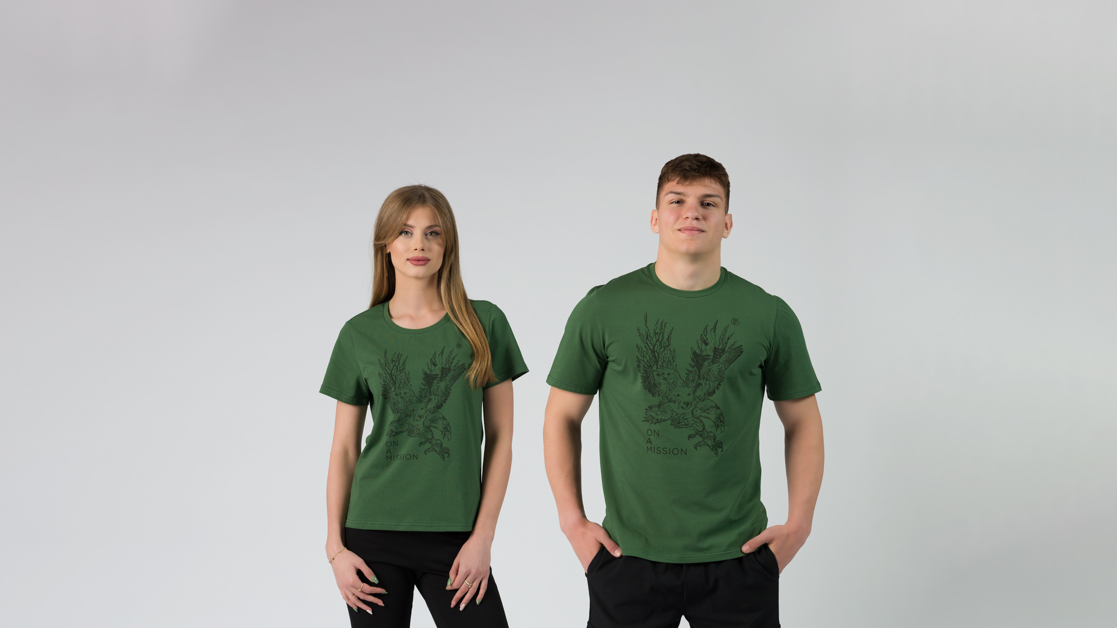 Girl with blond hair and man with dark hair wearing green t-shirts