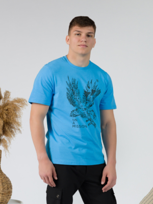 Young man wearing organic cotton blue color t-shirt with colored print and black trousers