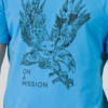 Young man wearing organic cotton blue color t-shirt with colored print and black trousers