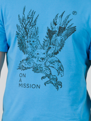 Young man wearing organic cotton blue color t-shirt with colored print and black trousers