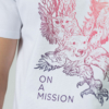 Young man wearing organic cotton white color t-shirt with colored print and black trousers