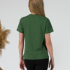 A young woman with blond hair wearing organic cotton green color t-shirt with colored print and black trousers
