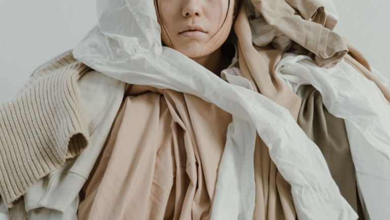 a woman overwhelmed by clothes