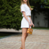 Young woman with blond hair wearing organic cotton white blouse t-shirt and organic cotton white shorts