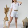 Young woman with blond hair wearing organic cotton white blouse t-shirt and organic cotton white shorts