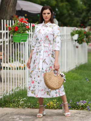 Woman wearing floral organic cotton shirt dress with bracelet sleeves coconut buttons and waist belt