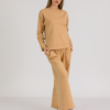 woman with blond hair wearing brown organic cotton long sleeve off shoulder boat neck blouse and brown organic cotton long wide legs pants