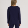 woman with blond hair wearing dark blue organic cotton long sleeve off shoulder boat neck blouse and dark blue organic cotton long tapered leg pants