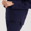 woman with blond hair wearing dark blue organic cotton long sleeve off shoulder boat neck blouse and dark blue organic cotton long tapered leg pants