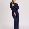woman with blond hair wearing dark blue organic cotton long sleeve off shoulder boat neck blouse and dark blue organic cotton long wide legs pants