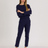 woman with blond hair wearing dark blue organic cotton oversized polo collar sweatshirt and dark blue organic cotton long tapered leg pants
