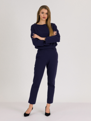 woman with blond hair wearing dark blue organic cotton oversized polo collar sweatshirt and dark blue organic cotton long tapered leg pants