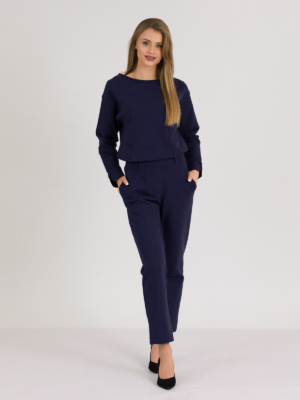 woman with blond hair wearing dark blue organic cotton oversized polo collar sweatshirt and dark blue organic cotton long tapered leg pants