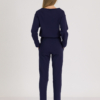 woman with blond hair wearing dark blue organic cotton oversized polo collar sweatshirt and dark blue organic cotton long tapered leg pants