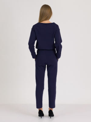 woman with blond hair wearing dark blue organic cotton oversized polo collar sweatshirt and dark blue organic cotton long tapered leg pants