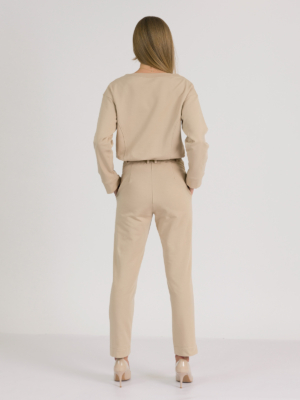 woman with blond hair wearing beige organic cotton elegant blouse and beige organic cotton long tapered leg pants
